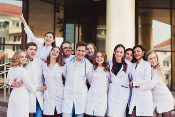 Fototapeta na wymiar Education and health. general practitioner. A group of smart medical students in college. Friends interns on the background of the hospital.