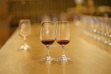 A glass of red wine is on the table