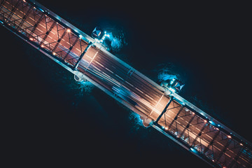 Beautiful evening scene with the famous Tower Bridge of St.Petersburg illuminated and reflected in Neva river