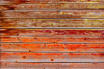 Old Board painted with orange red paint. Worn wood texture, background.