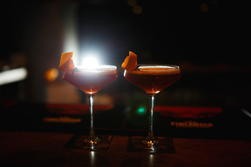 Two cocktails at the bar. Dark key photo