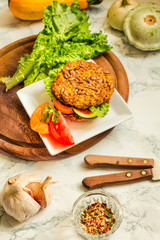 Baked vegan burgers with beans and seeds, vegetables and herbs. Healthy lifestyle and balanced food concept.