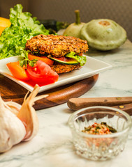 Baked vegan burgers with beans and seeds, vegetables and greens. Healthy lifestyle and balanced food concept. Selective focus.
