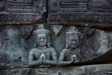 Fototapeta na wymiar Stunning bas relief sculptures celebrating hindu and buddhist figures captured at Bayon temple in the Angkor Thom temple complex, Siem Reap, Cambodia