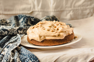 A chocolate banana cake on white plate with whipping cream. Kinfolk and comfort food atmosphere concept.