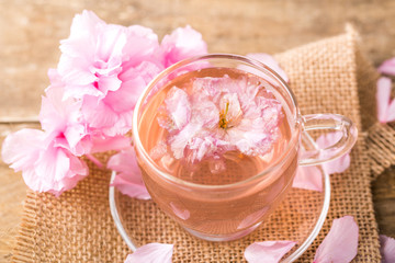 Obraz na płótnie Canvas Cherry blossom herb tea on table. sakura