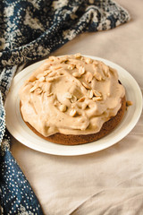 A chocolate banana cake on white plate with whipping cream. Kinfolk and comfort food atmosphere concept.