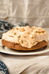 A chocolate banana cake on white plate with whipping cream. Kinfolk and comfort food atmosphere concept.