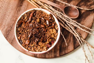 Cherry crumble with chocolate granola served served in portioned red cups.Top view. Close-up.