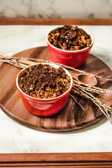 Cherry crumble with chocolate granola served served in portioned red cups.Selective focus.