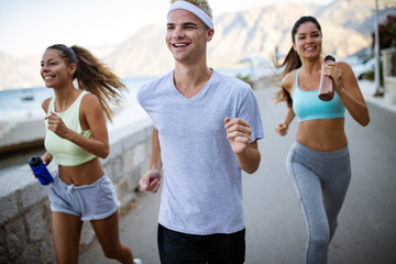Happy people jogging outdoor. Running, sport, exercising and healthy lifestyle concept