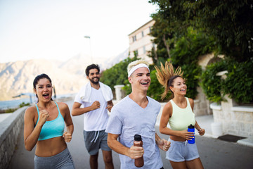 Happy people jogging outdoor. Running, sport, exercising and healthy lifestyle concept