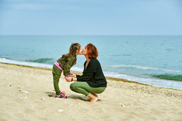 Mom and daughter on a walk on the sea coast .