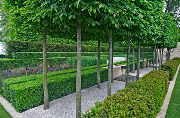 A classical garden with an avenue of yew, box and hornbeam leading to a water feature and sculpture