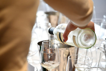 woman pouring wine from wine bottle, rest