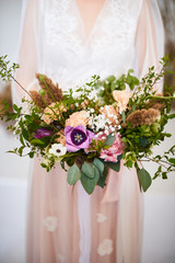 Delicate wedding bouquet in the hands of the bride