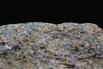 Rock or stone on black background. Granite crouan rim or pick edge like cliff or mountain. Geology mineral texture isolated closeup on two thirds