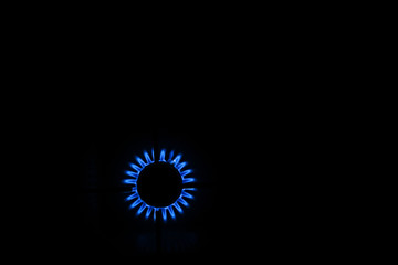 Blue flame of a gas stove in the dark. gas-burner