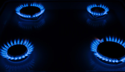 Blue flame of a gas stove in the dark. gas-burner