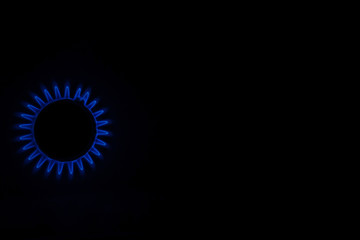 Blue flame of a gas stove in the dark. gas-burner