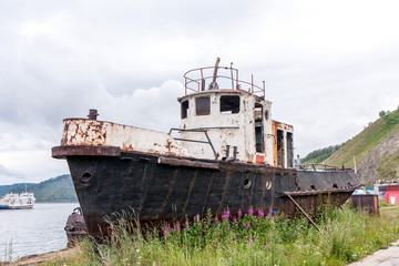 Old rusty fishing boat near the shore
