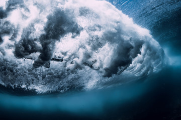 Barrel wave underwater with air bubbles. Ocean in underwater