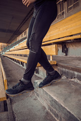 Caucasian man trains in running on the stairs. Track and field runner in sport uniform training outdoor. athlete, top view. step exercise. steps down