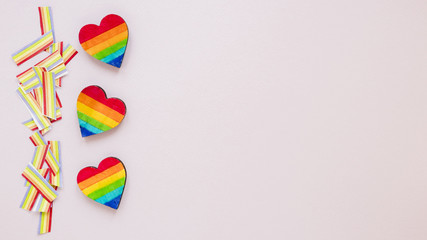 Three rainbow hearts with paper rainbows on table