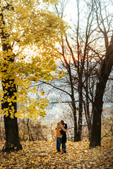 Fototapeta premium attractive happy luxury couple walking and holding hands in autumn colorful park