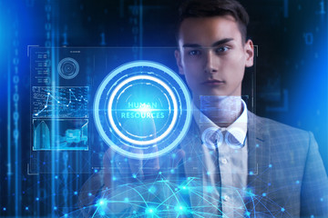 The concept of business, technology, the Internet and the network. A young entrepreneur working on a virtual screen of the future and sees the inscription: Human resources