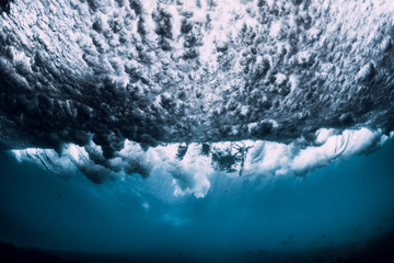 Barrel wave underwater with air bubbles. Ocean in underwater