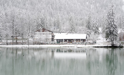 Snow falling over Dobiacco lake in Italy, Europe