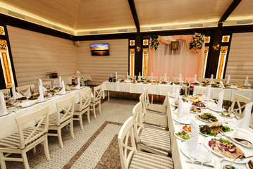 stylish fashionable decorated table with flowers and delicious food, celebration wedding, catering in the restaurant