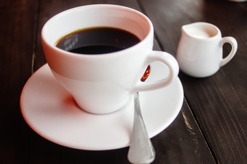 beautiful stylish stunning white cups with coffee and milk on a wooden table