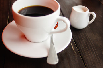 beautiful stylish stunning white cups with coffee and milk on a wooden table