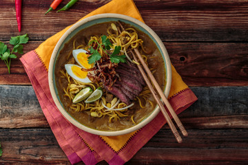 Malaysia Spicy Noodle Mee Rebus With Beef Egg and fried onion, copy space