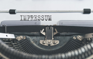 close-up of word IMPRESSUM, German for copyright page or imprint or publishing information, written...