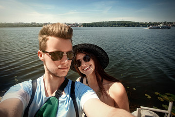 Fototapeta na wymiar happy stylish couple taking selfie, having fun on the beach, summer vacation