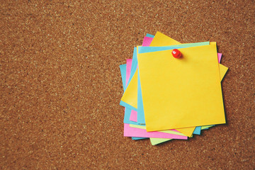 collection of colorful variety. paper note pad reminder sticky notes pin paper yellow on cork...