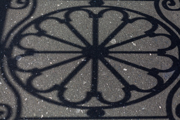 Shadow of  round design on asphalt
