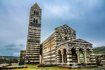 The Basilica della Santissima Trinità di Saccargia (Basilica of the Holy Trinity), a romanesque church in northern Sardinia, Italy. Entirely built with local black basalt and  limestone.