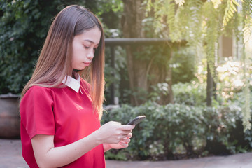 Close up woman using smart phone at the park