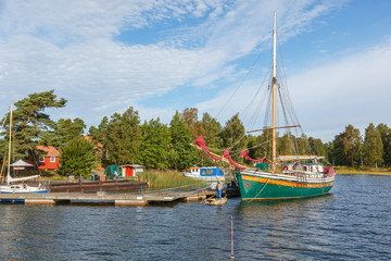 Fototapeta na wymiar Sailboat in harbor at an archipelago island