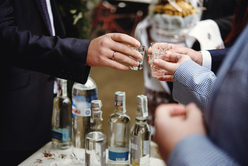 hands of people with  glasses of alcohol, celebrating and toasting, wedding or birthday event
