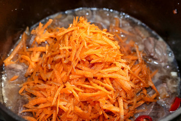 Grated fresh carrot close up.