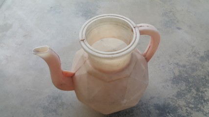 Closeup view of a lota placed over grey concrete floor.