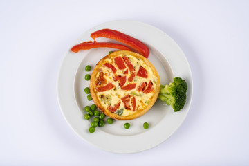 Broccoli cheddar mini savory pies on white plate. Delicious appetizers, snack, tapas. Flat lay.