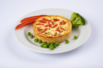 Broccoli cheddar mini savory pies on white plate. Delicious appetizers, snack, tapas. Flat lay.