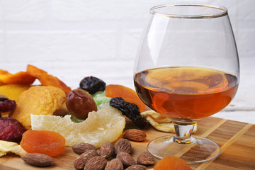 mix of dried fruits and nuts on a dark wood background. tinting. selective focus.