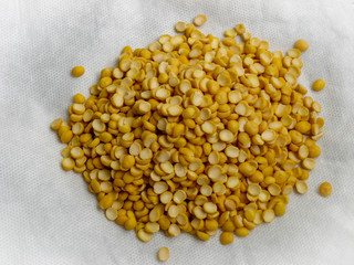 Close up of yellow split dried peas on white background. High view